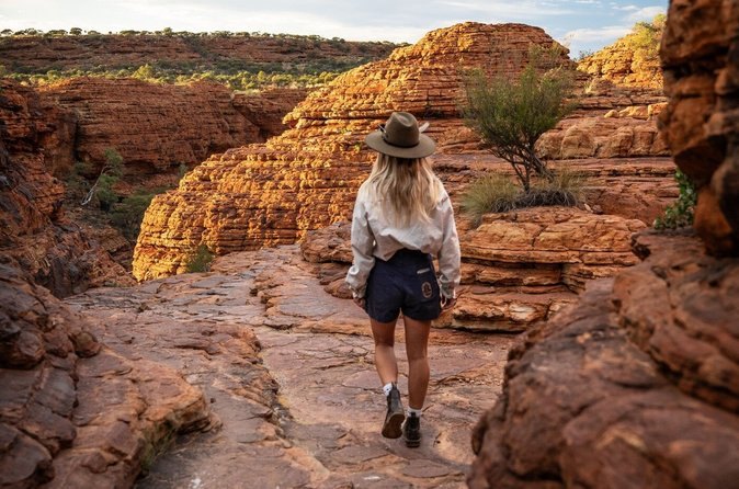 A walker on the rock steps between two of the Kata Tjuta domes