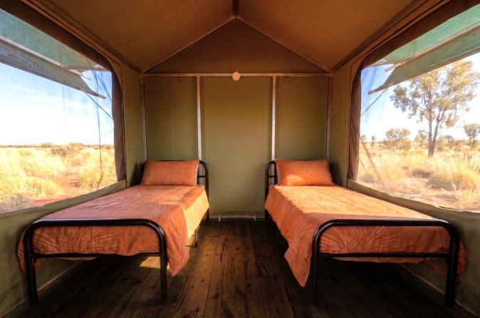 Twin beds inside one of the permanent eco tents used on the camping trips