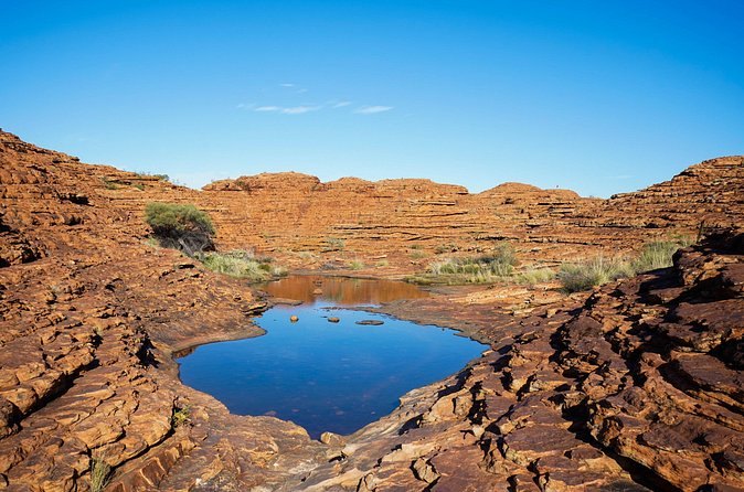 A rock pool on the rim of Kings Canyon under a clear sky