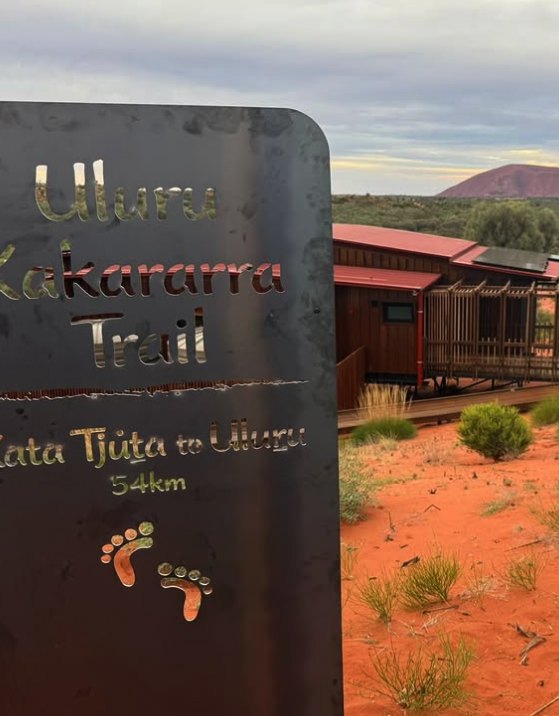 The Uluru-Kata Tjuta National Park entry sign on the road in
